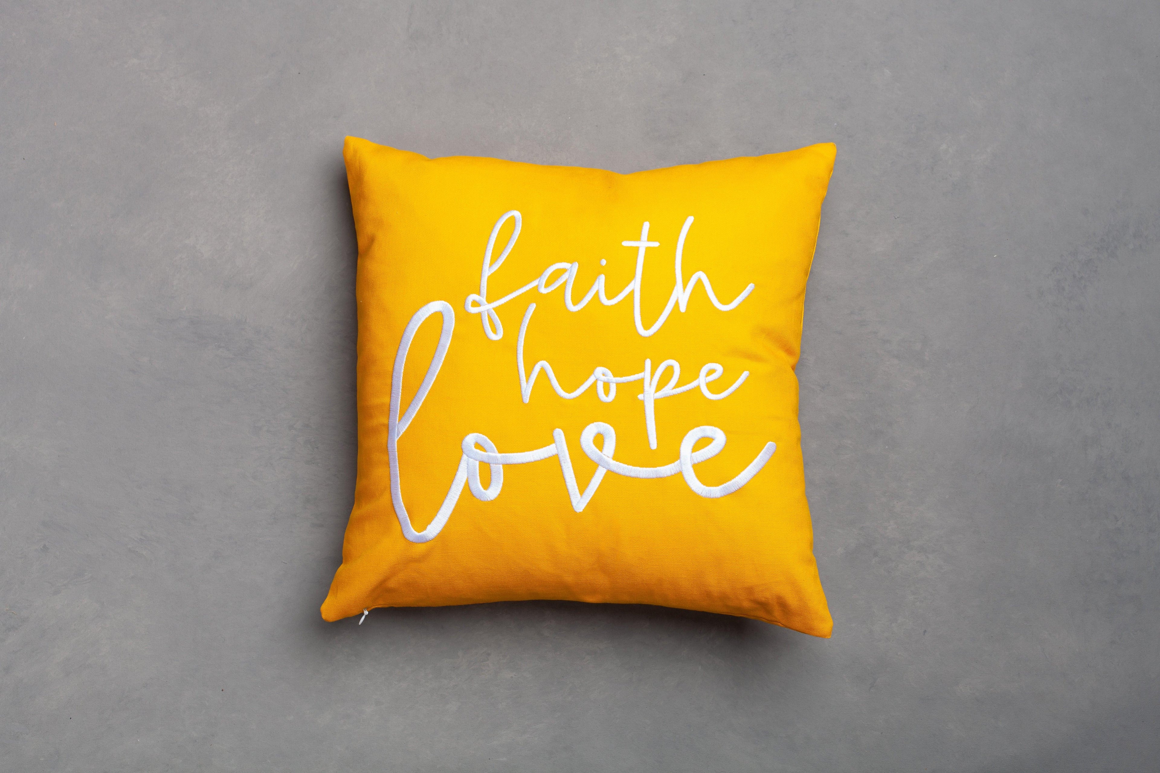 Yellow Faith Hope Love embroidered scripture pillow cover – bright hand-stitched 1 Corinthians 13:13 verse on neutral grey, ideal Christian gift accent