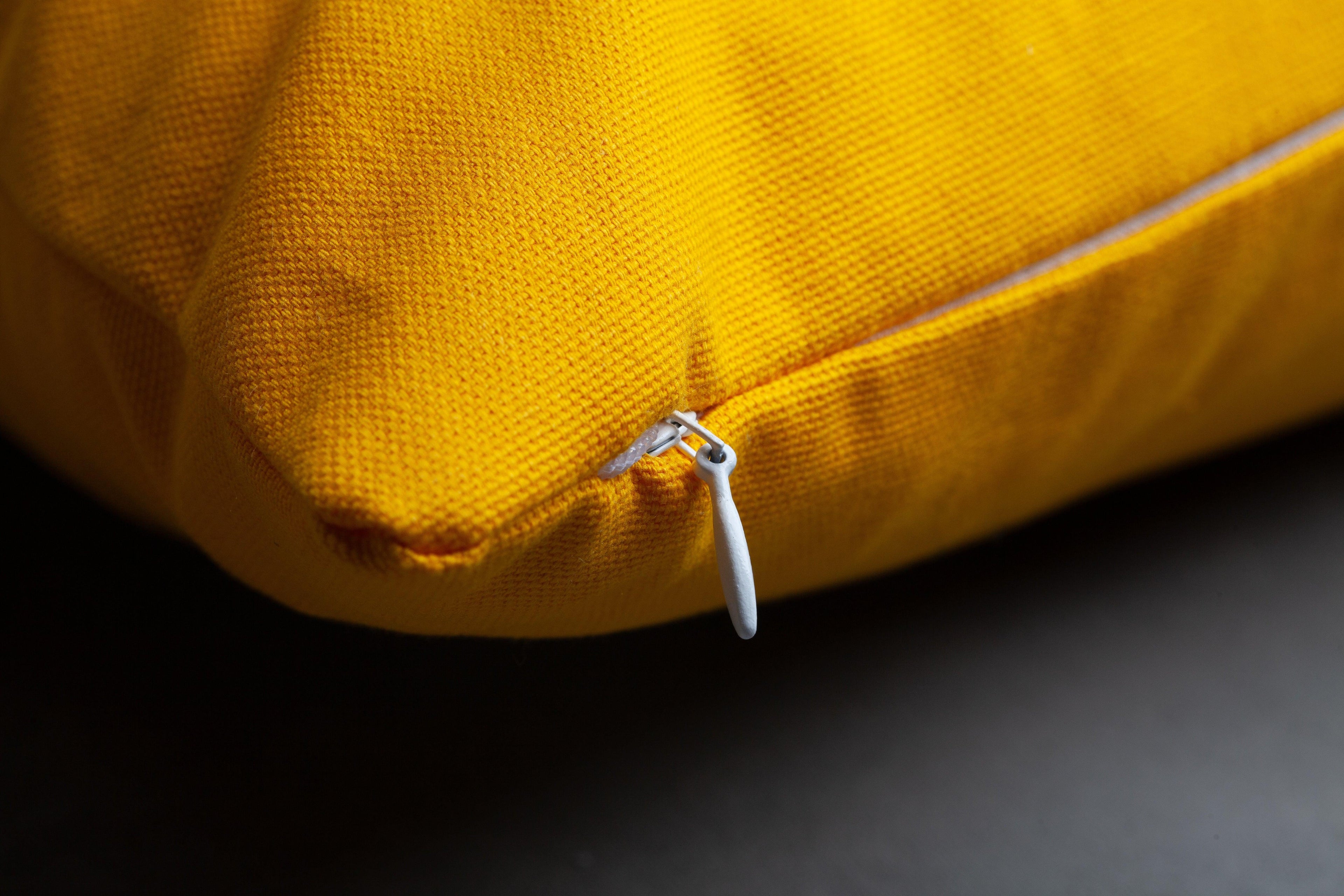 Close-up of concealed zipper on yellow Joy & Strength embroidered pillow cover – removable feature highlighting detailed Nehemiah 8:10 'joy of the Lord is your strength' embroidery