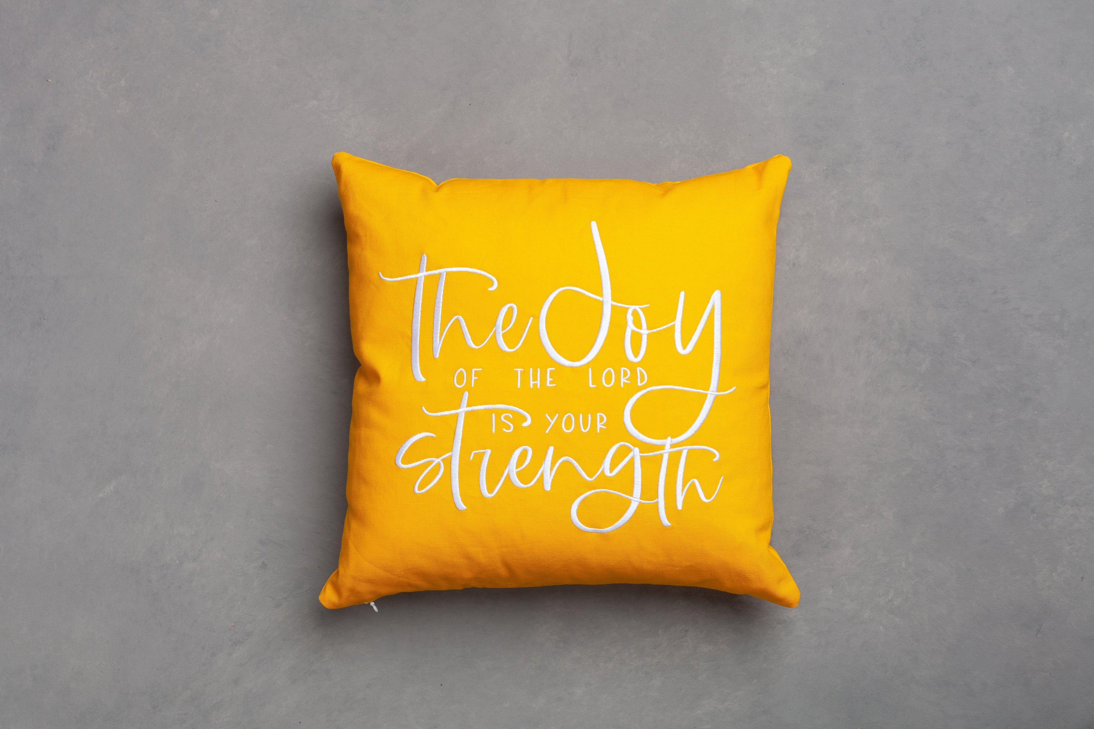 Yellow Joy & Strength embroidered scripture pillow cover – bright Nehemiah 8:10 'joy of the Lord is your strength' on neutral grey, empowering faith gift